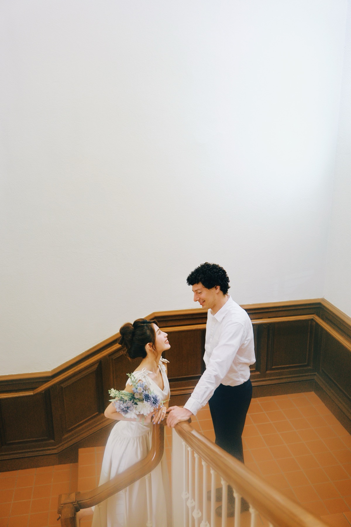 Couple on a staircase with a bouquet