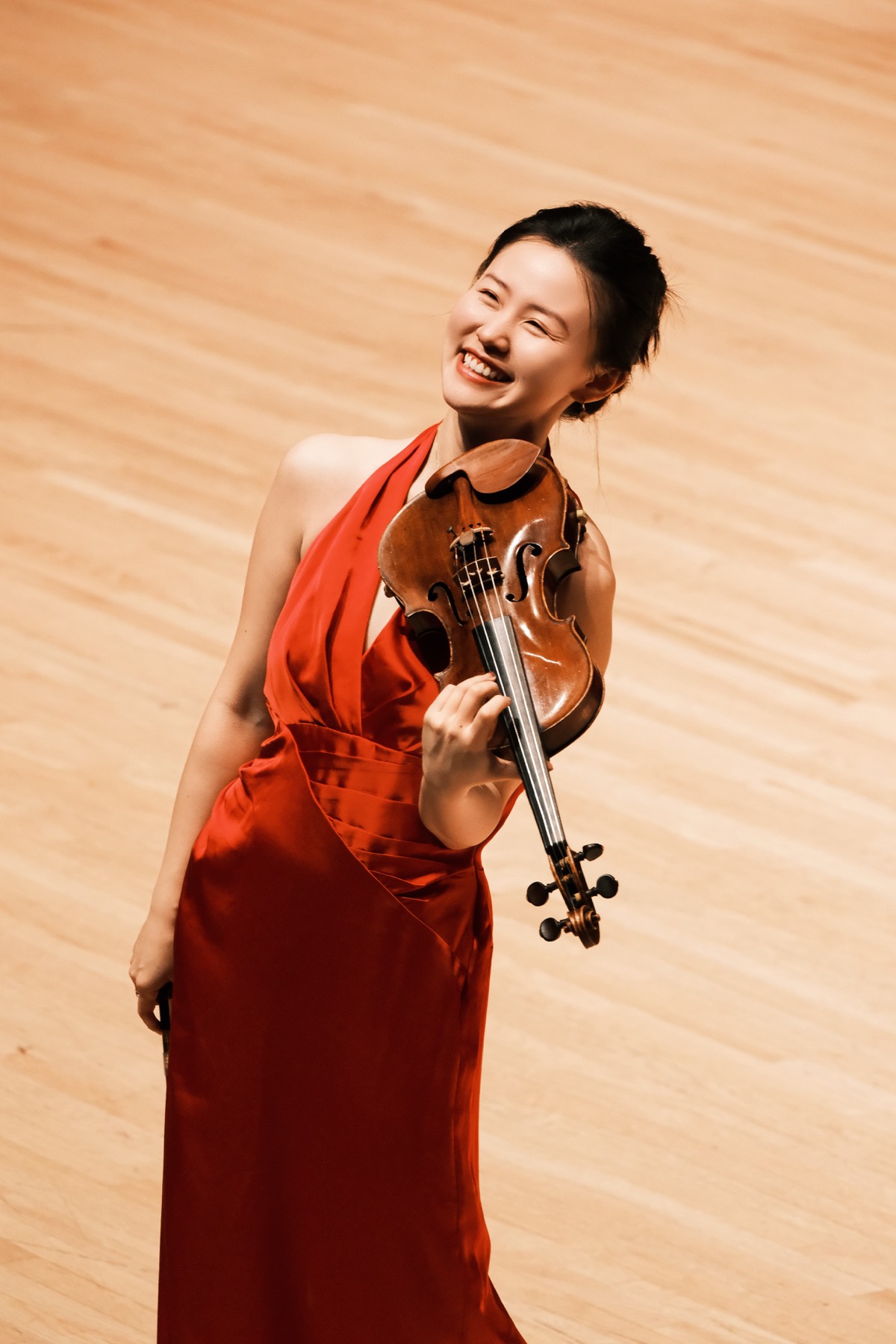 Violinist performing in a red gown