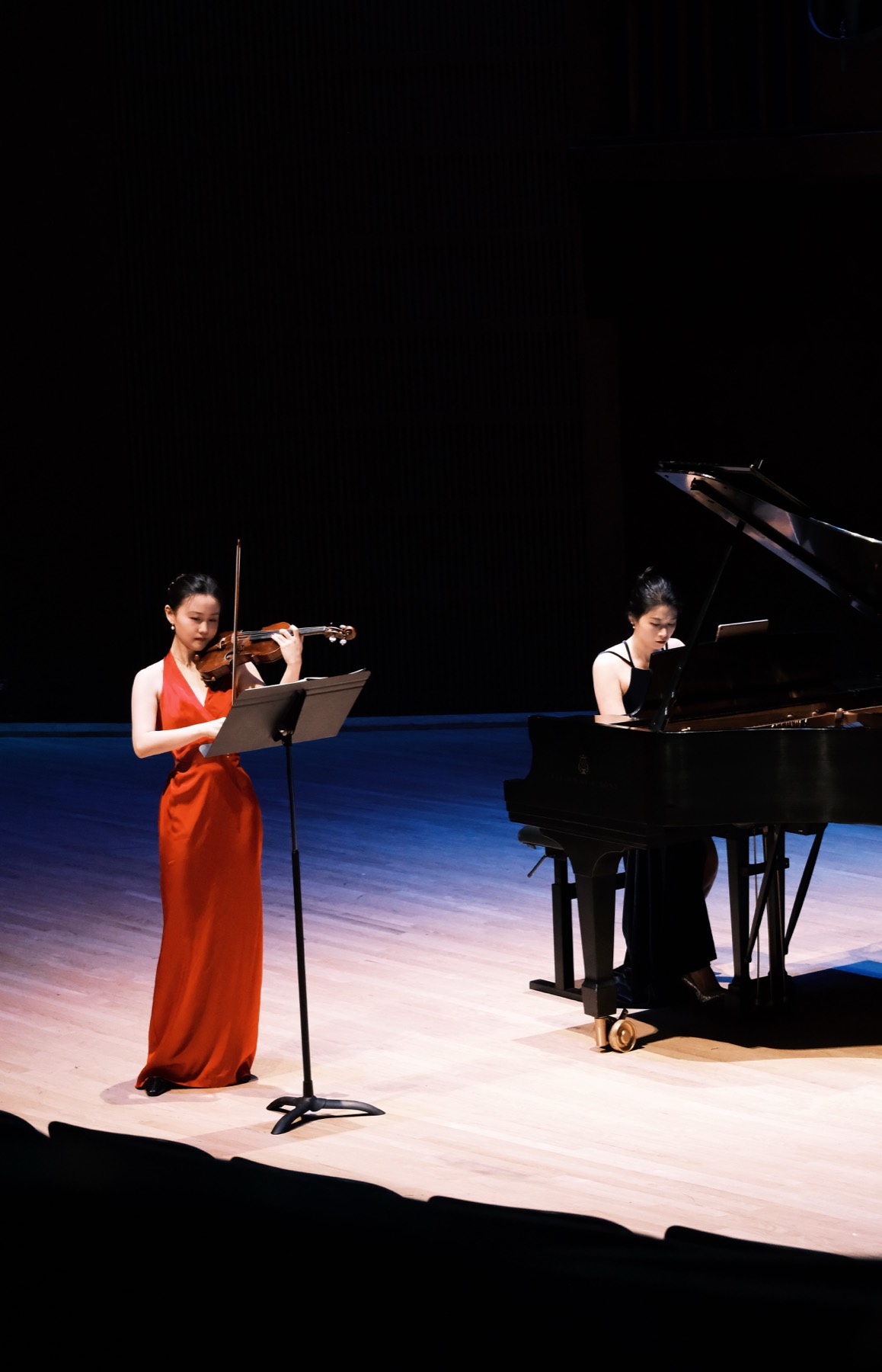 Violinist and pianist performing onstage