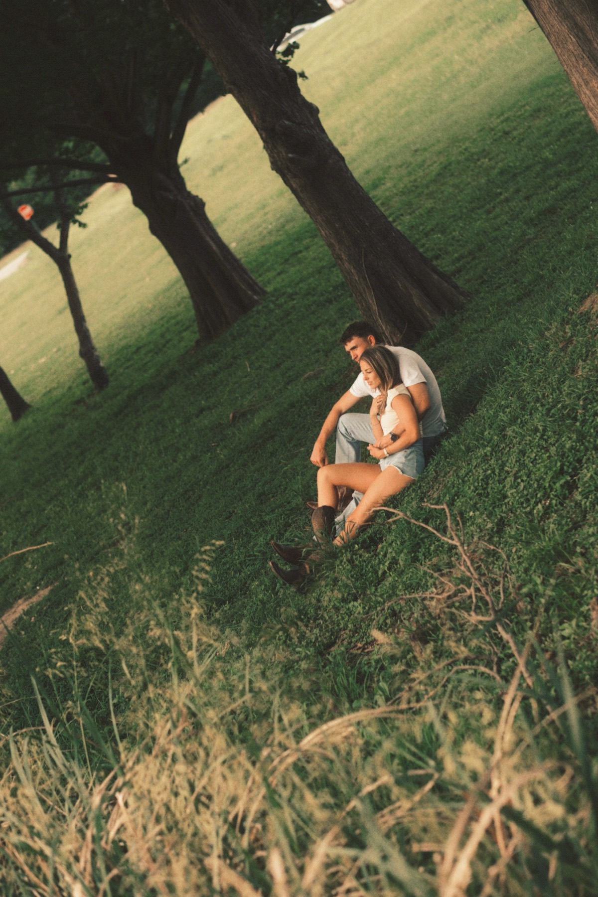 Couple sitting together under trees