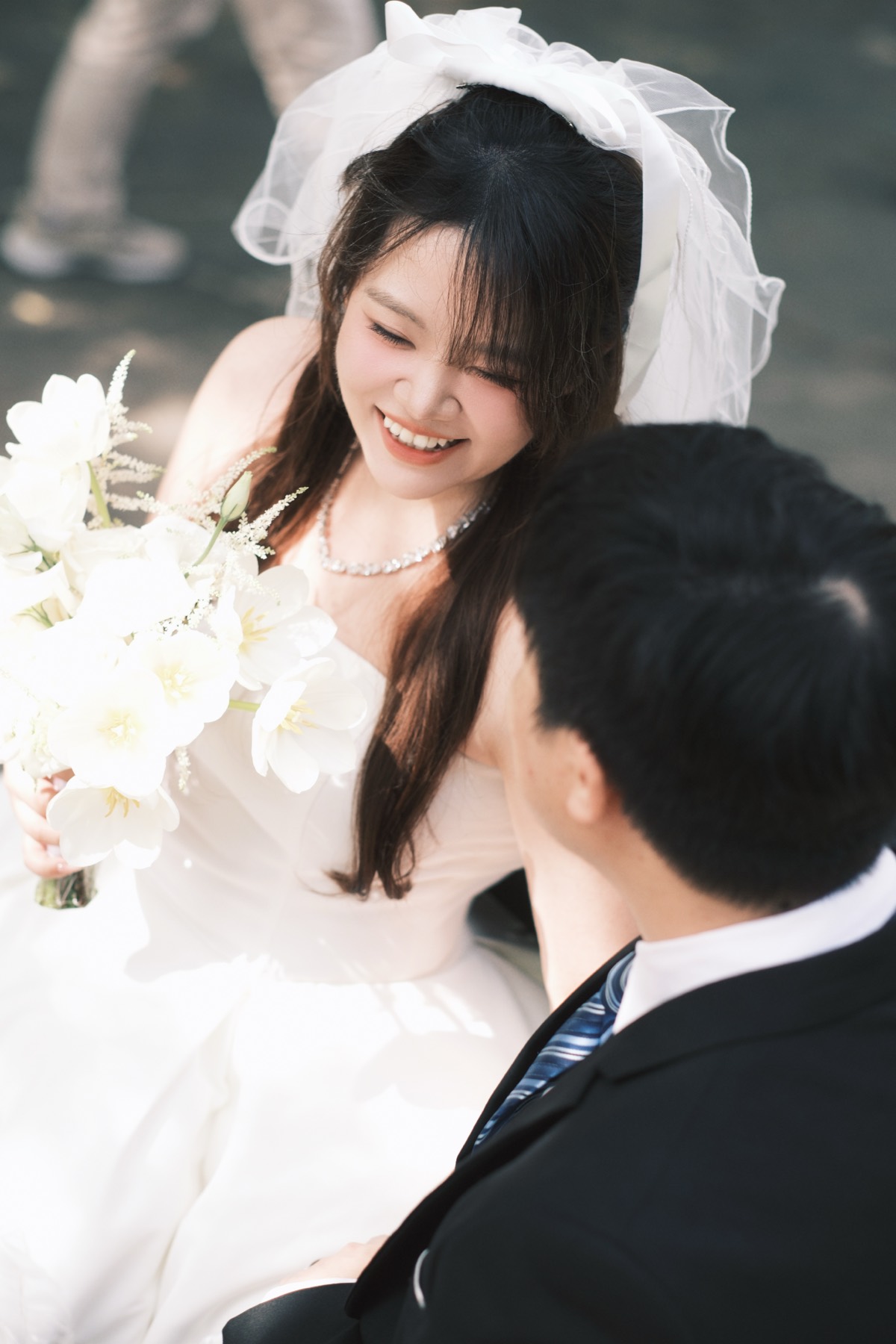Bride in veil smiling at groom