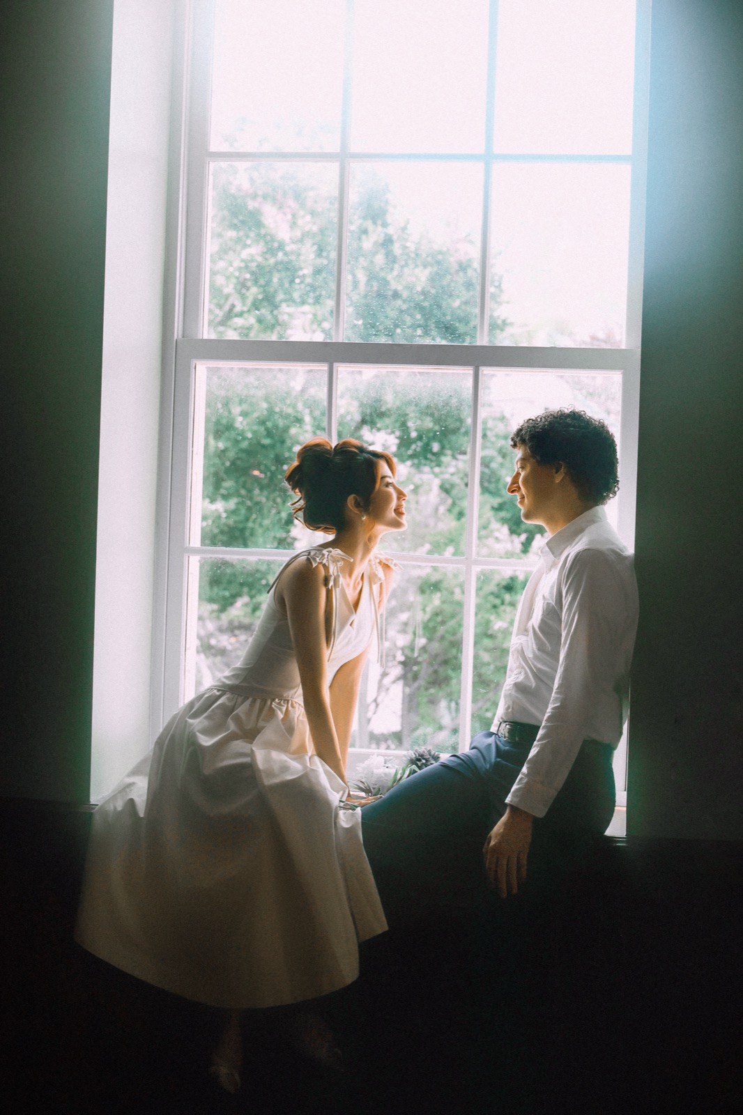 Couple in a backlit window nook