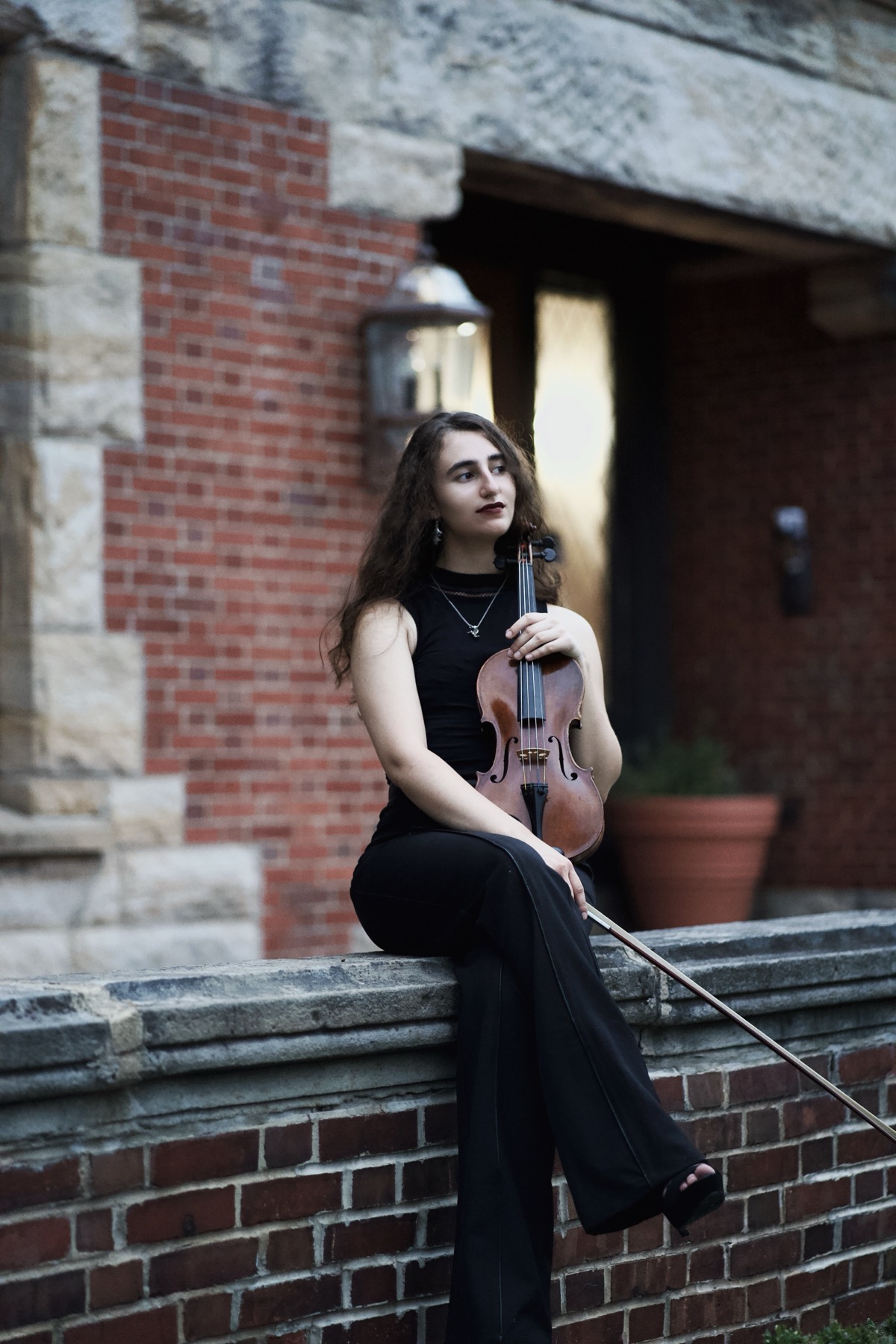 Violinist portrait outside a brick building