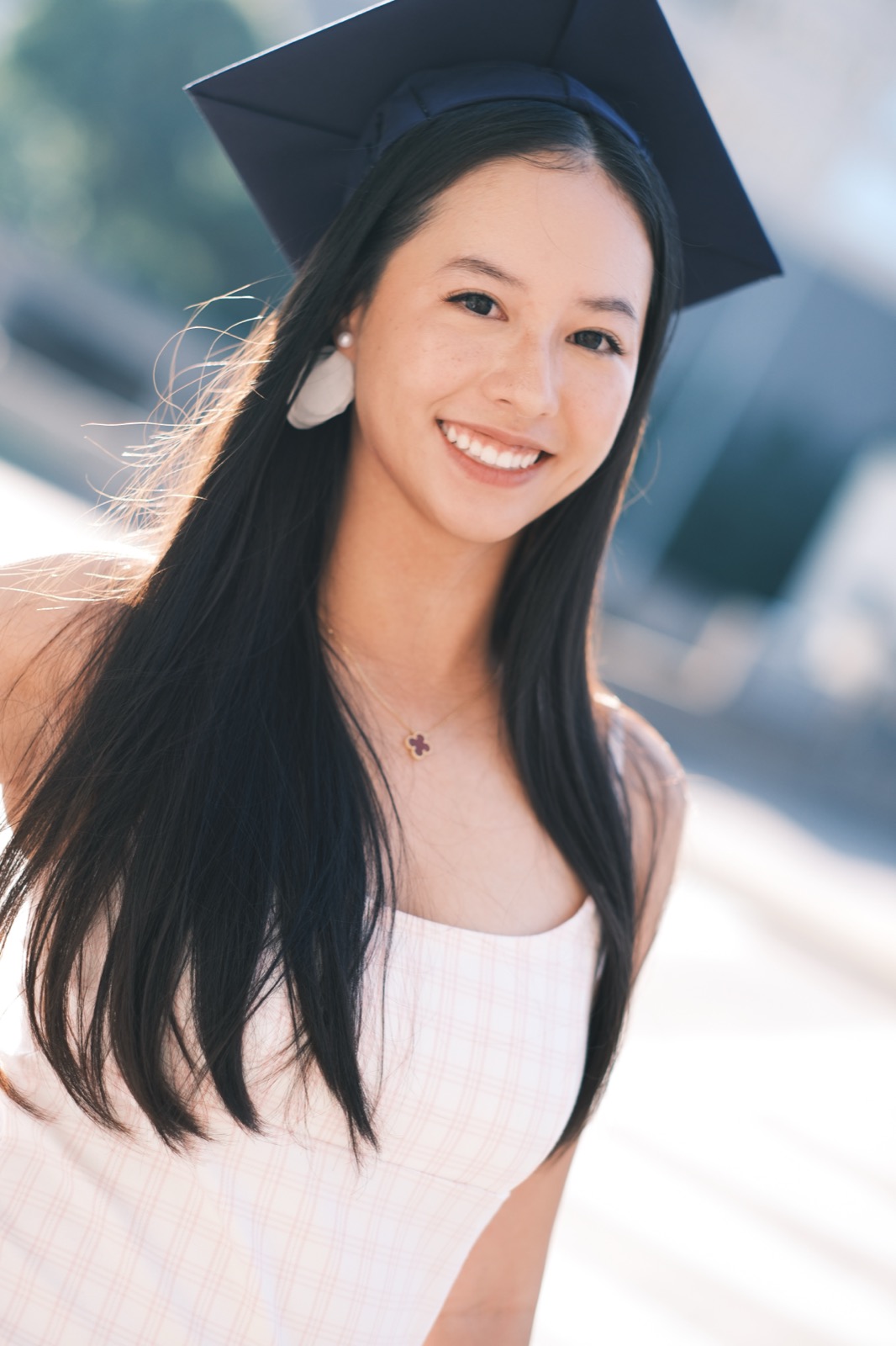 Graduate smiling in cap outdoors