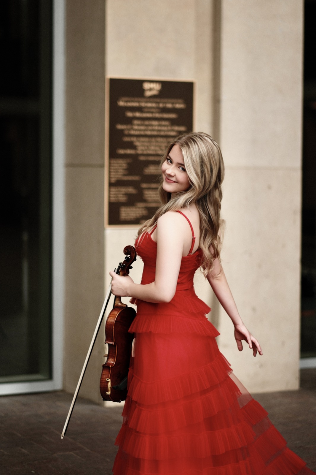 Violinist in wood-paneled hall