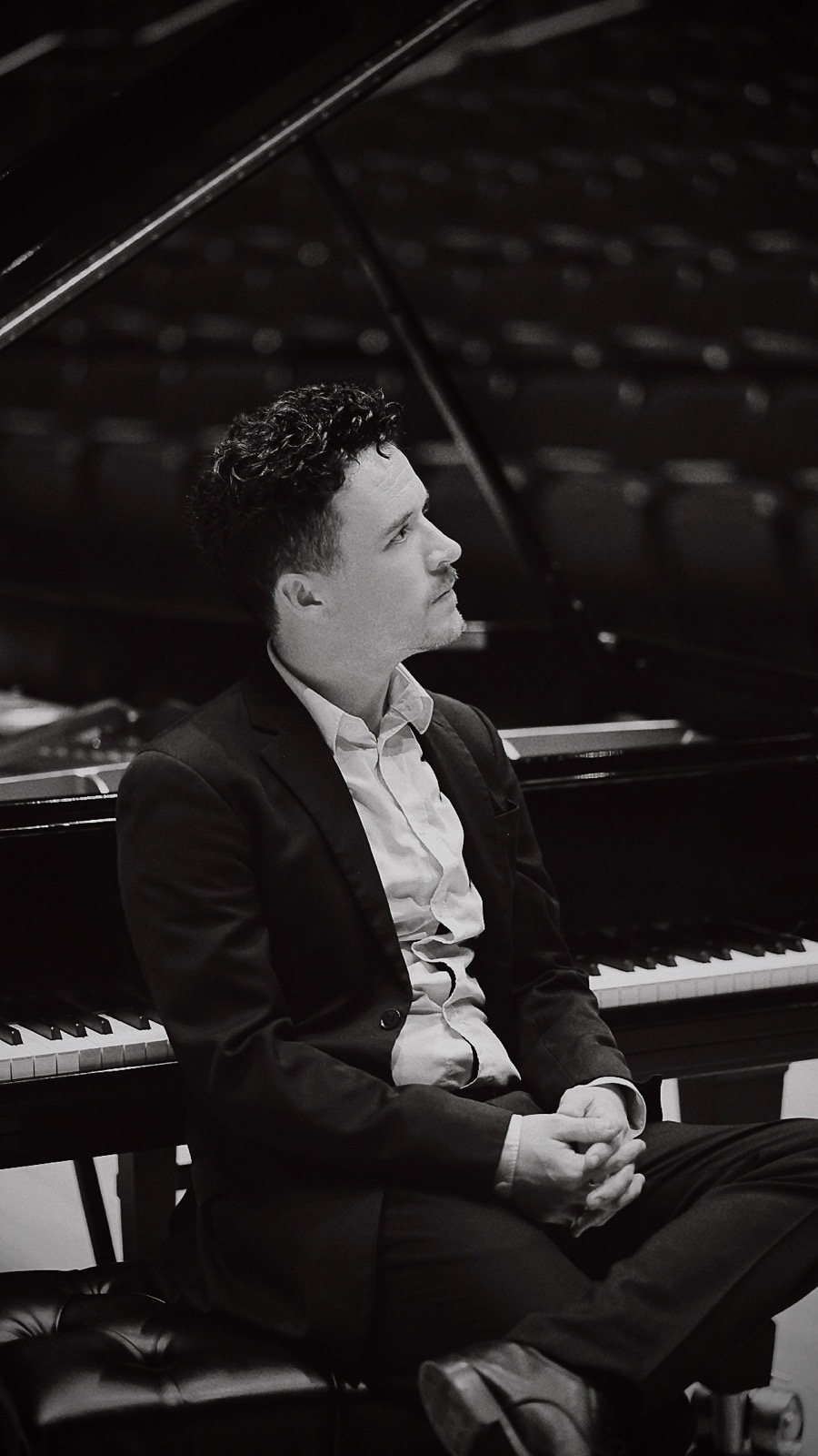 Pianist at grand piano, black and white